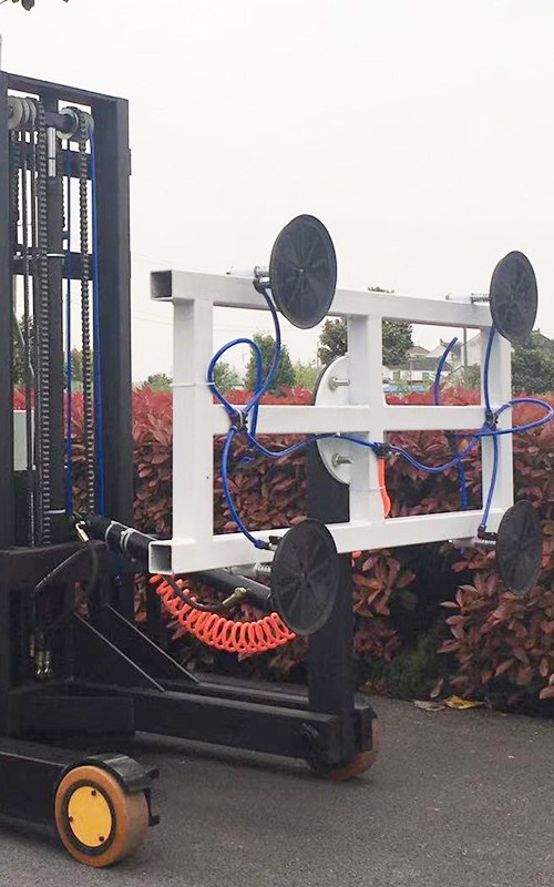 Reach forklift with vacuum attachment being used to handle glass