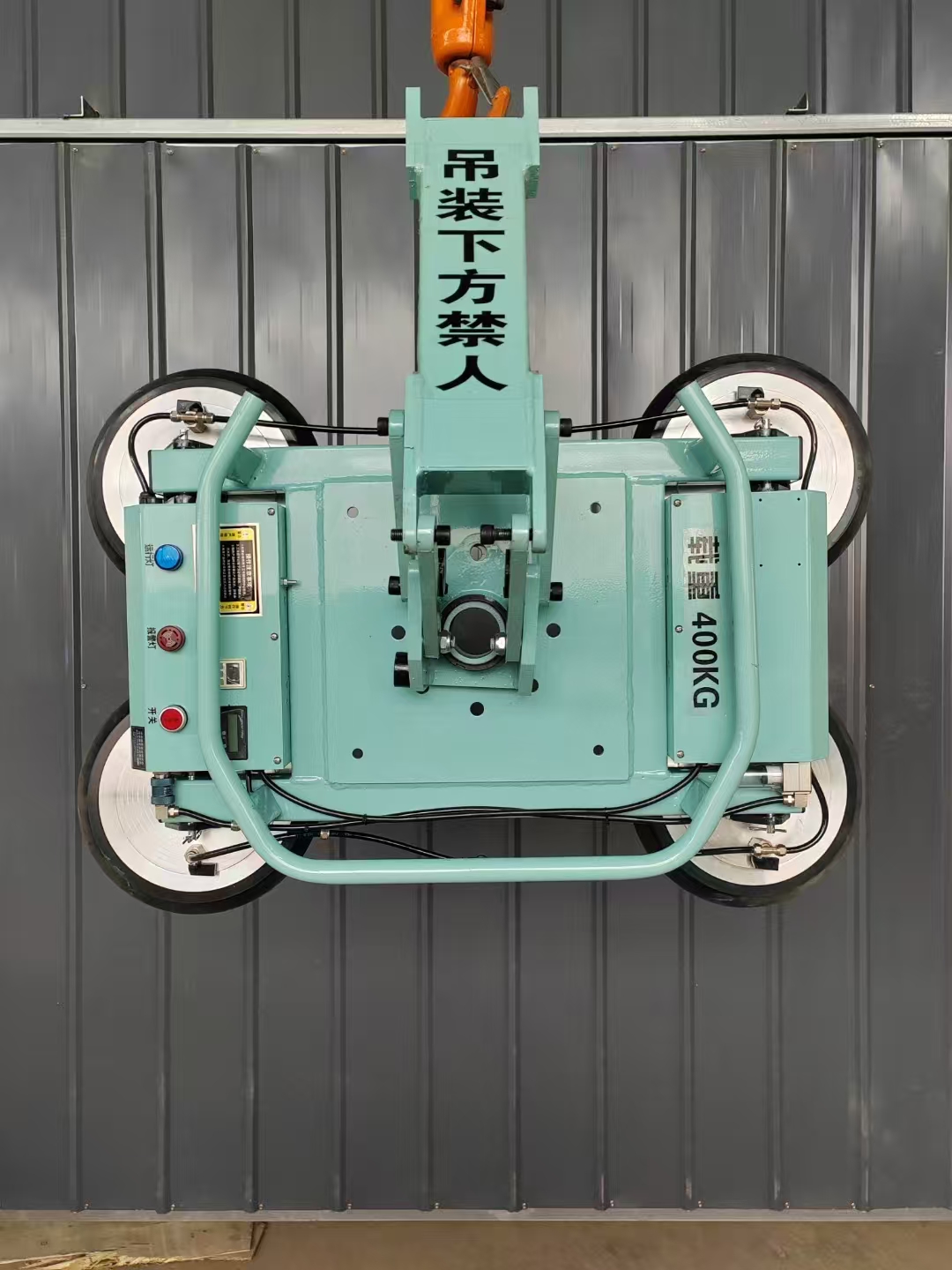 Crane-suspended vacuum lifter handling a flat glass panel