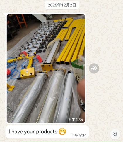 Yellow vacuum lifting beams, suction cups with shut-off valves and control boxes laid out for inspection before packing